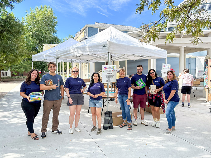Volunteers pose outside at the Historic Elitch Theater for a photo during the Multi-Day Used Book Sale. 